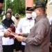 Wagub, Idris Rahim menyerahkan piagam penghargaan Satyalancana Karya Satya 30 tahun kepada PNS Kemenag pada peringatan HAB ke-76, di Alun-Alun Tilamuta, Kabupaten Boalemo, Senin (3/1/2022). (Foto. Haris)