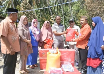 menyerahkan bantuan beras dan pakaian seragam sekolah kepada korban kebakaran keluarga Idrak Maliki di Desa Rumbia Kecamatan Botumoito, Kamis (15/9/2022).(f.ist)